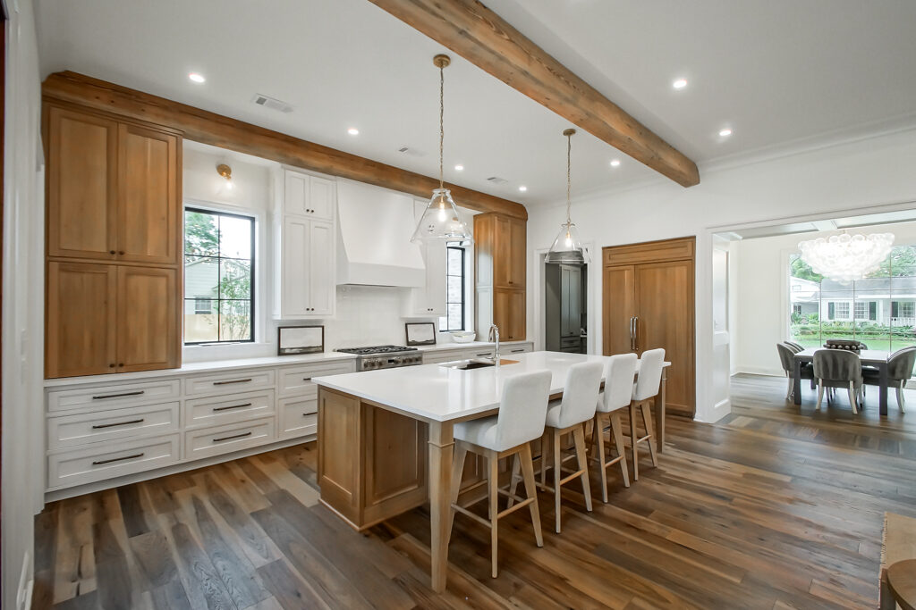 Custom kitchen with quartz island and wood beams in a Baton Rouge custom home