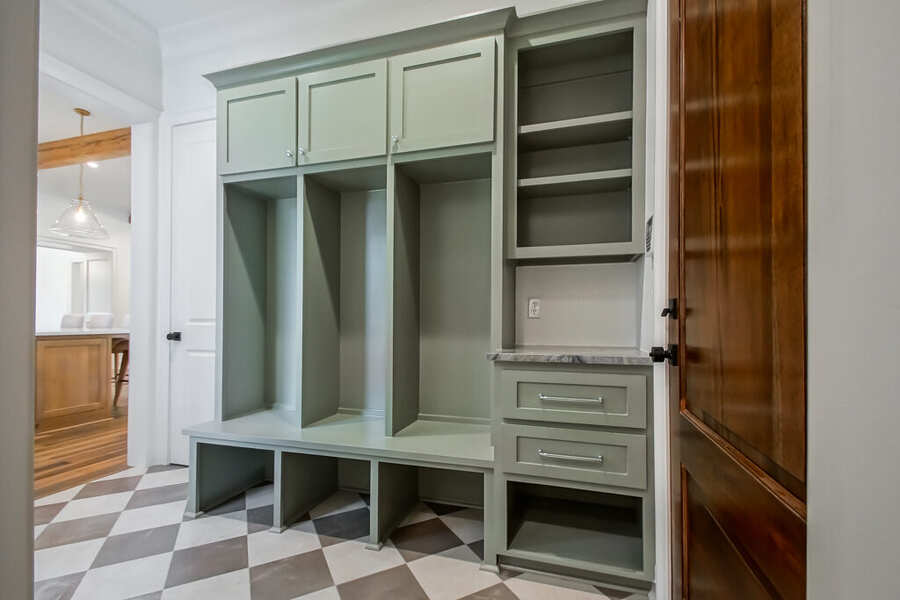 Mudroom with custom sage lockers and bench seating