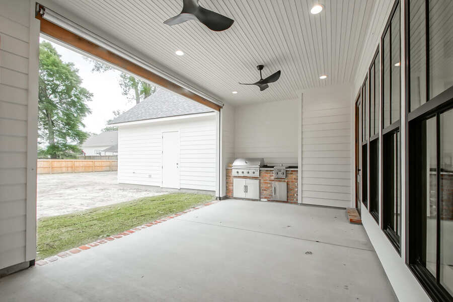Covered outdoor entertaining porch with outdoor kitchen