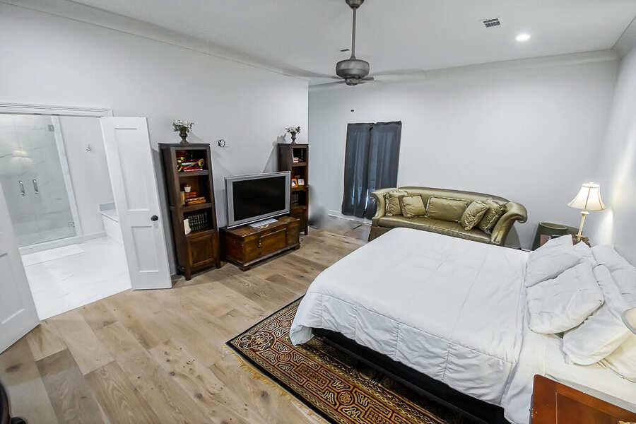 Primary bedroom suite opening directly to the marble primary bath