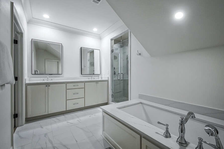Primary bath dual vanity with large format tile and designer fixtures