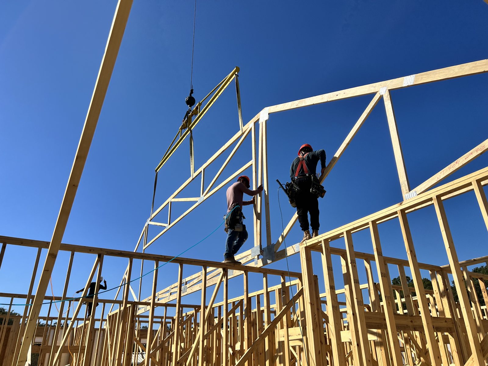Crane setting roof trusses on a Nelson Custom Builders commercial project