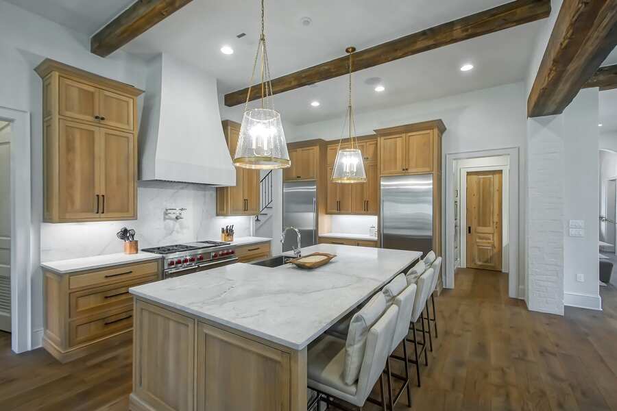 Chef's kitchen with reclaimed beams and professional range