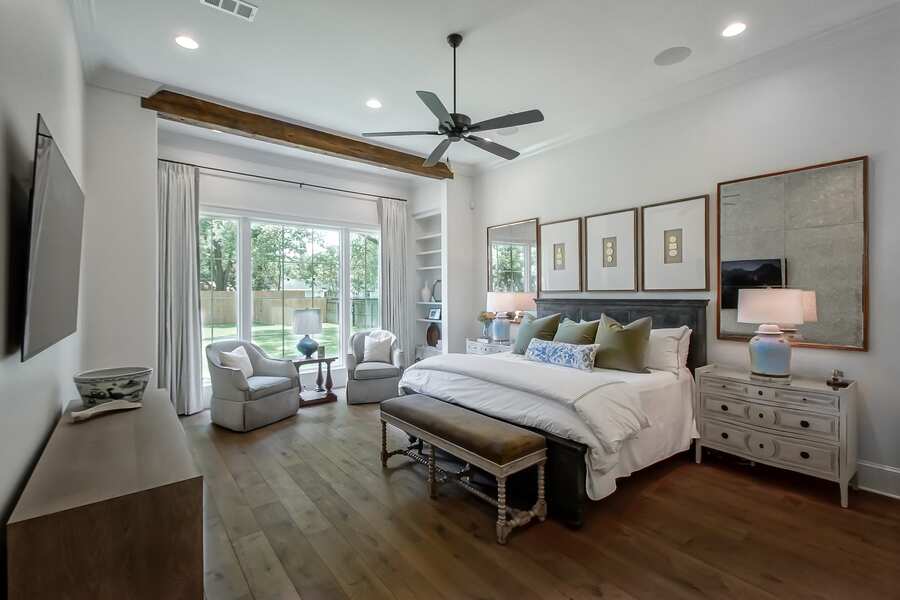 Primary bedroom suite with wood beam accent ceiling