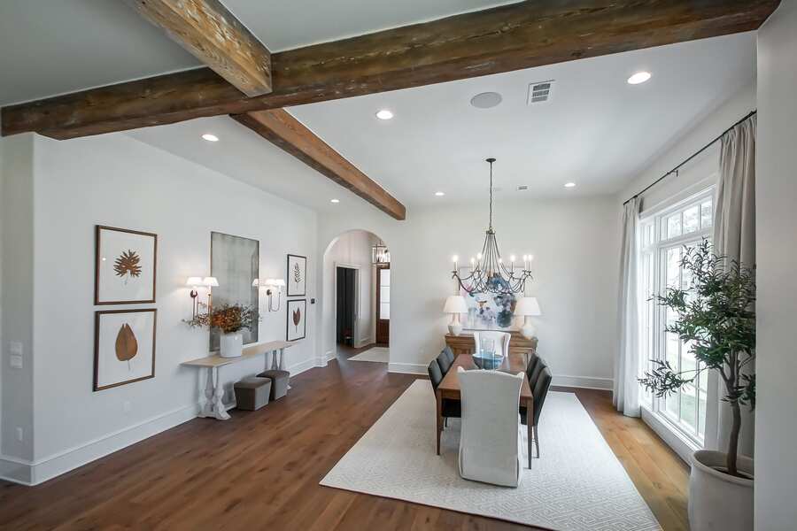 Formal dining room with chandelier and reclaimed beam accent