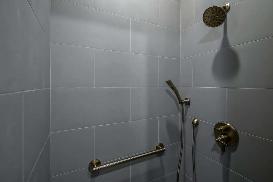 Tiled shower with brushed-gold fixtures