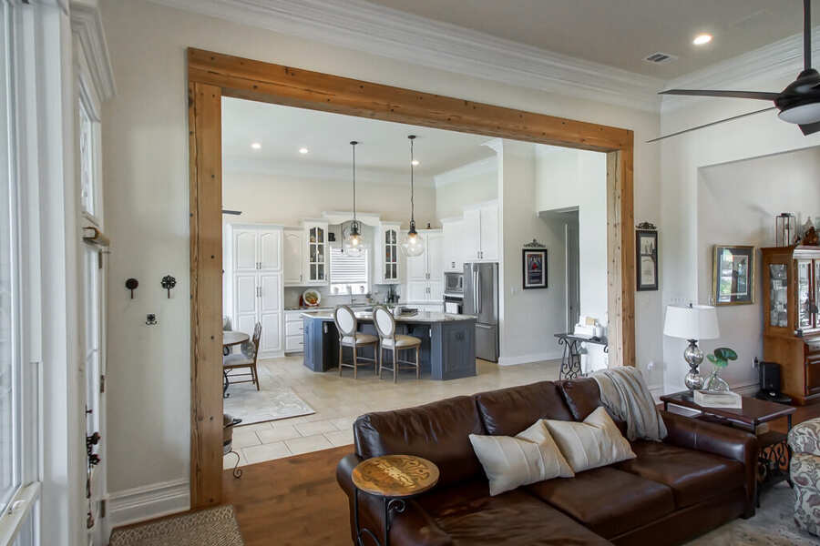View from the living room into the kitchen through the new beam-framed opening