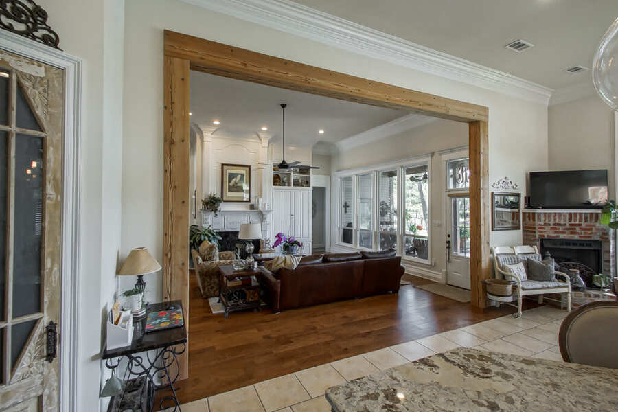 Reclaimed-cypress posts and header framing the living room opening