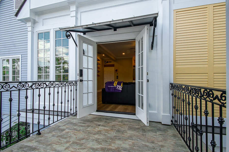 French doors opening onto the wrought-iron balcony