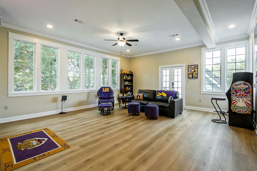 Second-floor bonus room with new wood flooring and a wall of windows, Baton Rouge