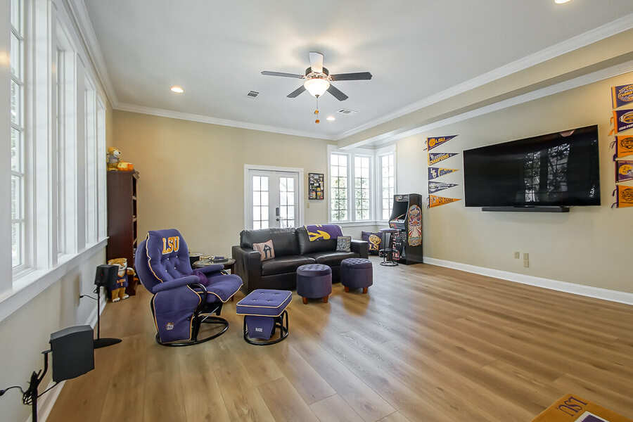 Bonus room with mounted TV and lounge seating