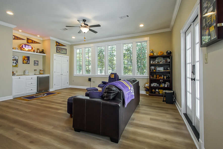 Bonus room built-ins and French door to the balcony