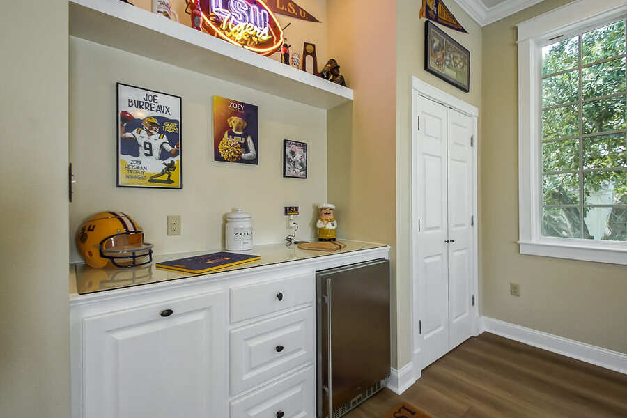Built-in wet bar with beverage refrigerator and floating shelf