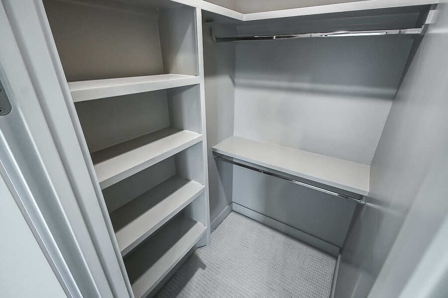 Custom closet with built-in shelving and hanging rods