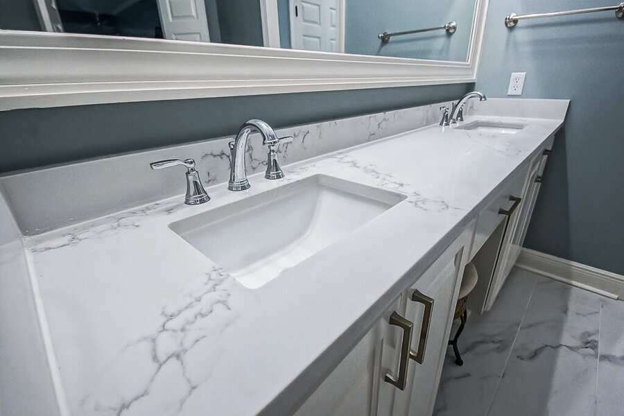 Quartz vanity top with undermount sinks and chrome faucets