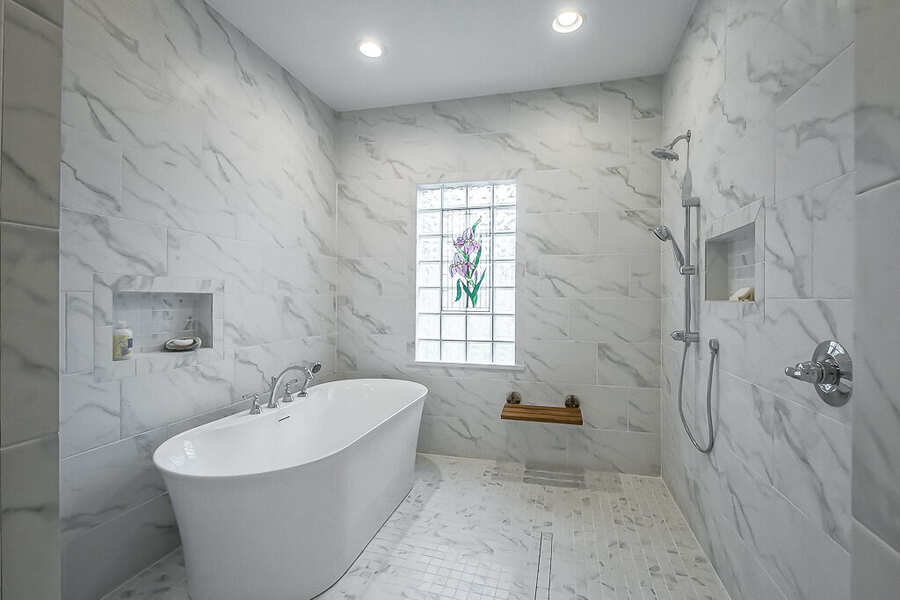 Primary bathroom renovation with marble wet room and freestanding tub, Baton Rouge
