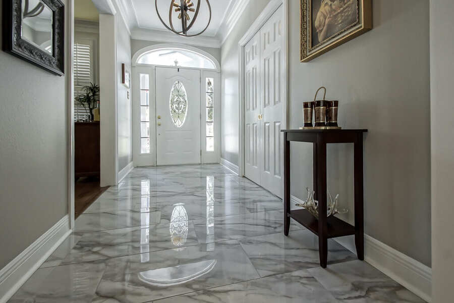 Entry foyer with marble-look porcelain tile flooring