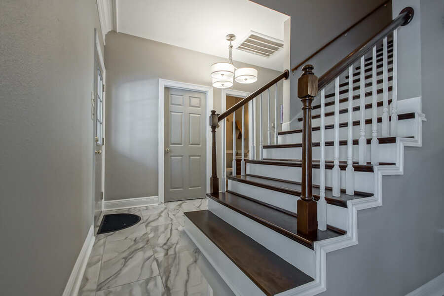 Refinished staircase with dark wood treads and white risers