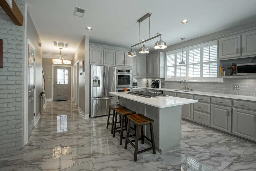 Kitchen with gas cooktop island and stainless wall ovens