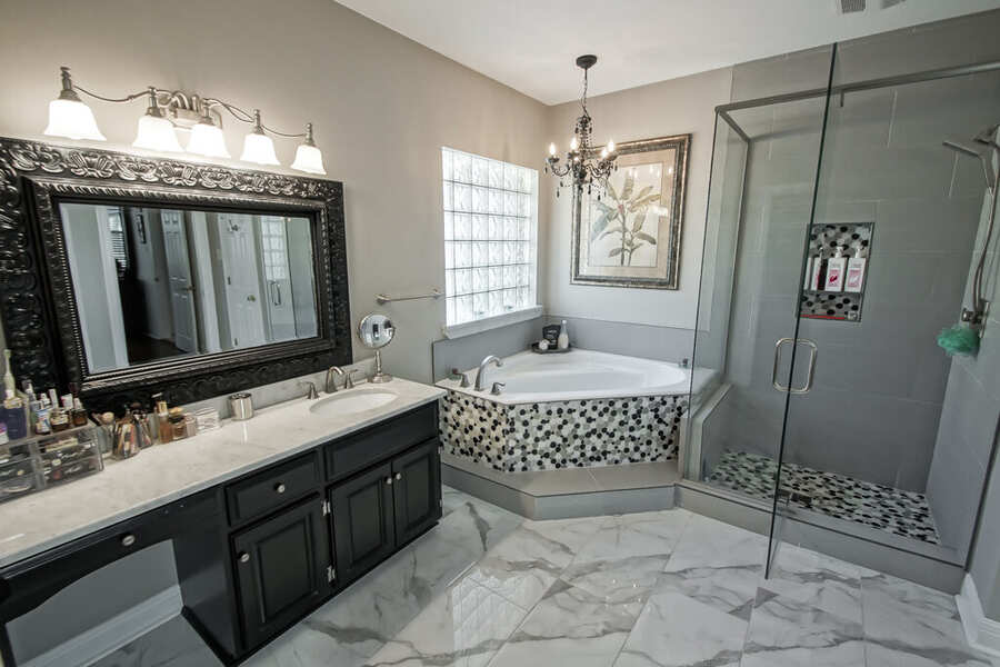 Primary bath dual vanity with a framed mirror and dressing area